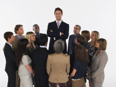 Group of Businesspeople Staring at Tall Man